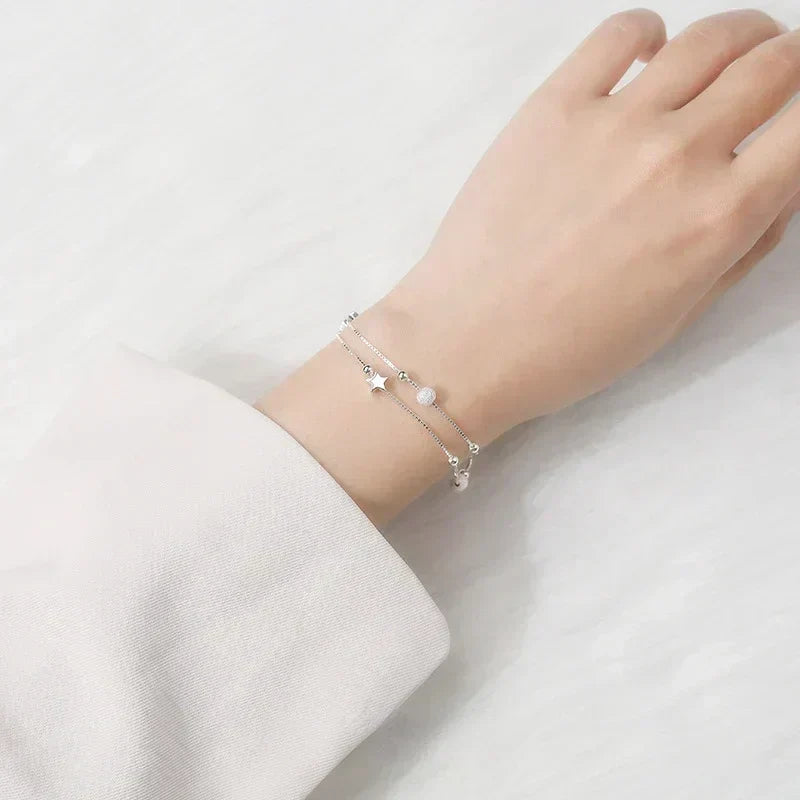 Woman wearing the Serena Delicate Silver Bracelet on her wrist