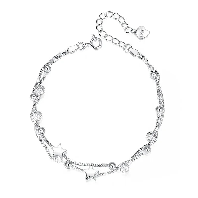Serena Delicate Silver Bracelet with star charms and stardust beads, on white background