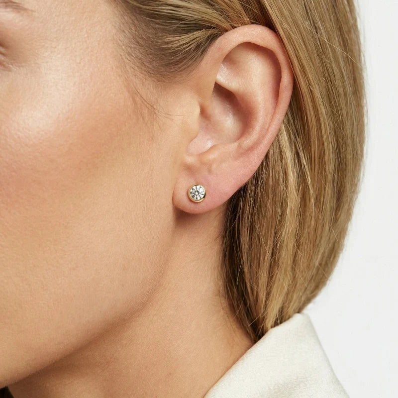 Amara Crystal Stud Earrings worn on ear – Gold