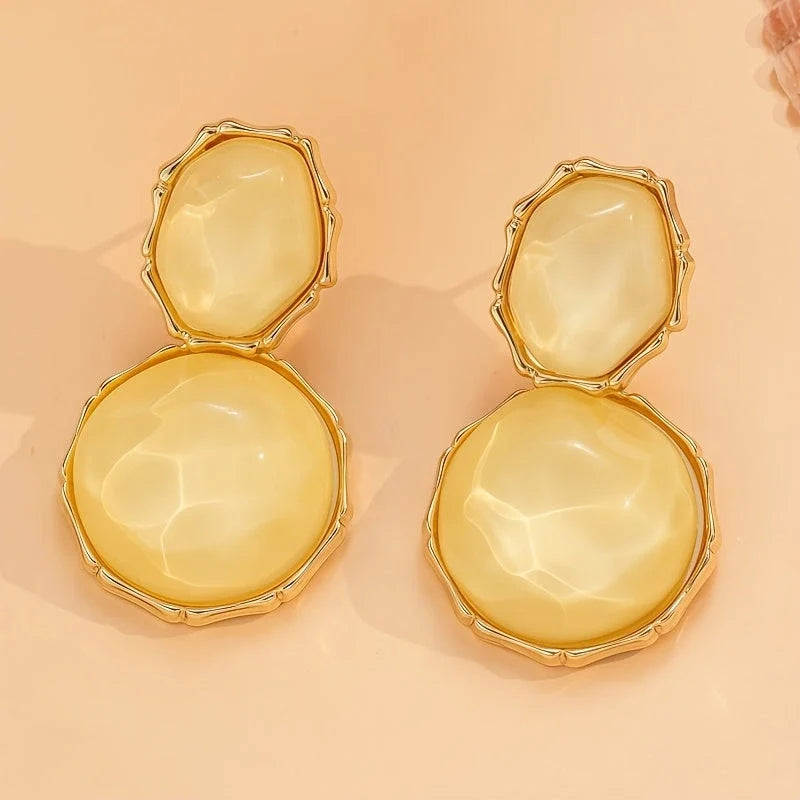 Bali Oval Resin Drop Earrings worn on wrist – Yellow