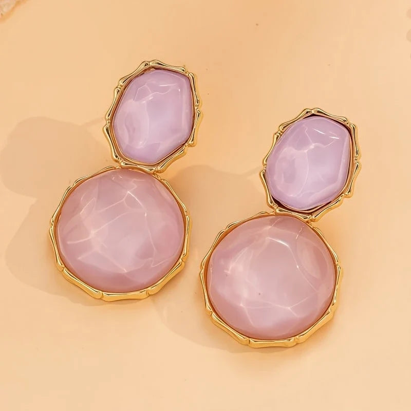 Bali Oval Resin Drop Earrings worn on wrist – Purple