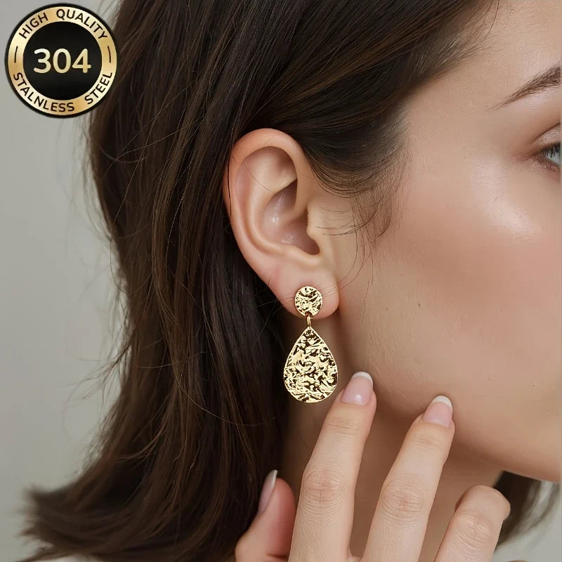 Delphine Gold Teardrop Earrings worn on ear