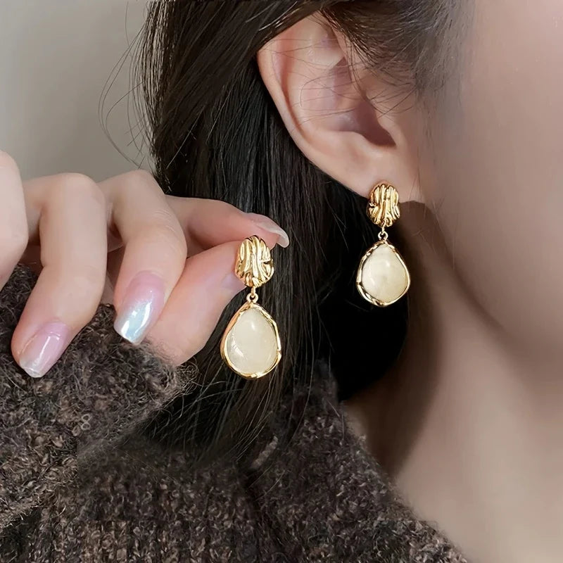 Ivory Muse Vintage Drop Earrings worn on ear and hand