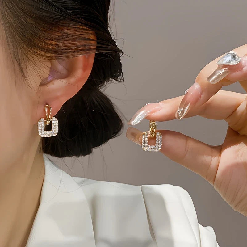 Valora Crystal Link Earrings worn on ear and hand
