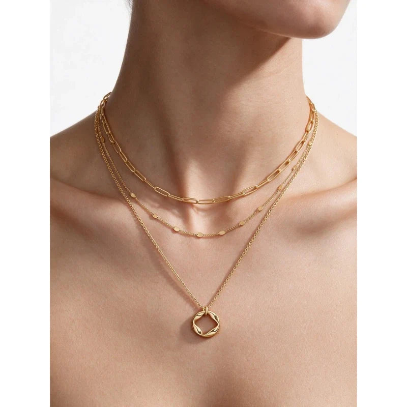 Model wearing Celeste Layers gold necklace set