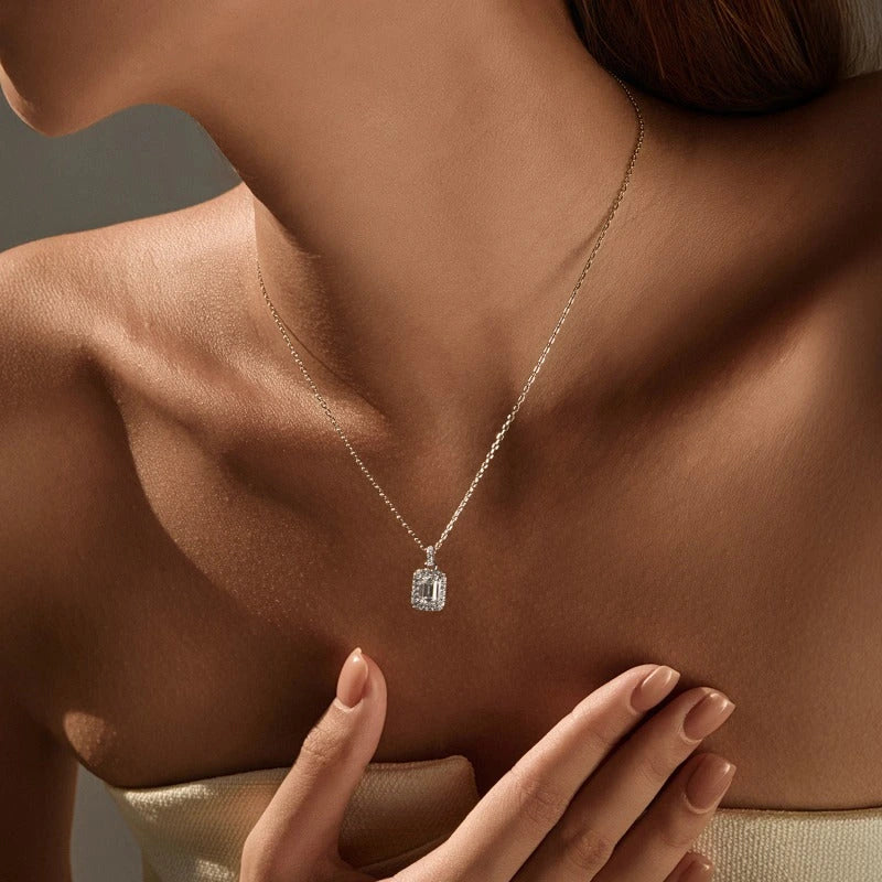 Model wearing Elysia emerald halo pendant necklace