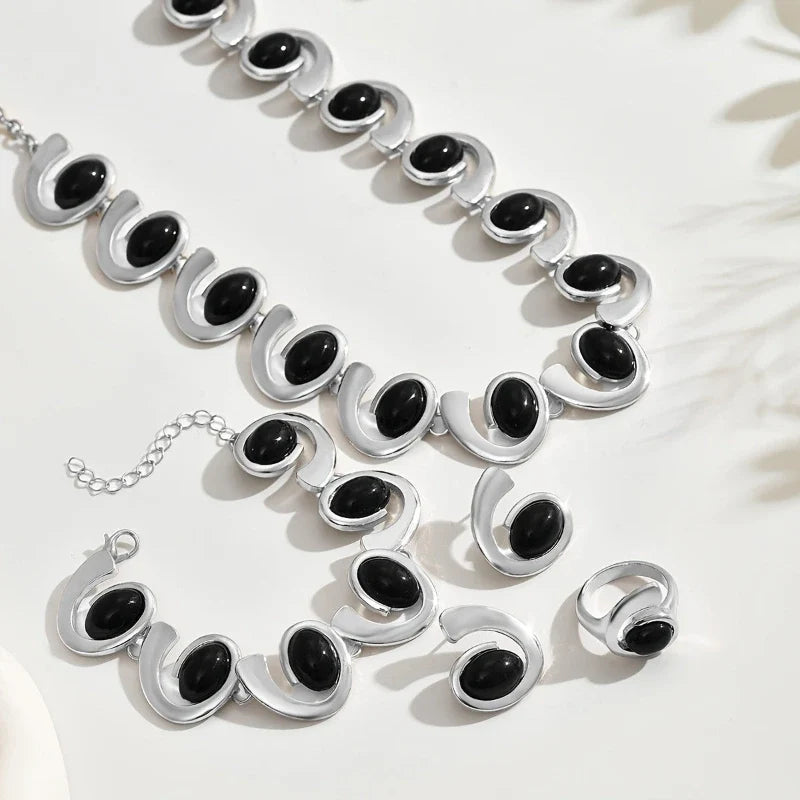 Noir Éclipse jewelry set flat lay detail